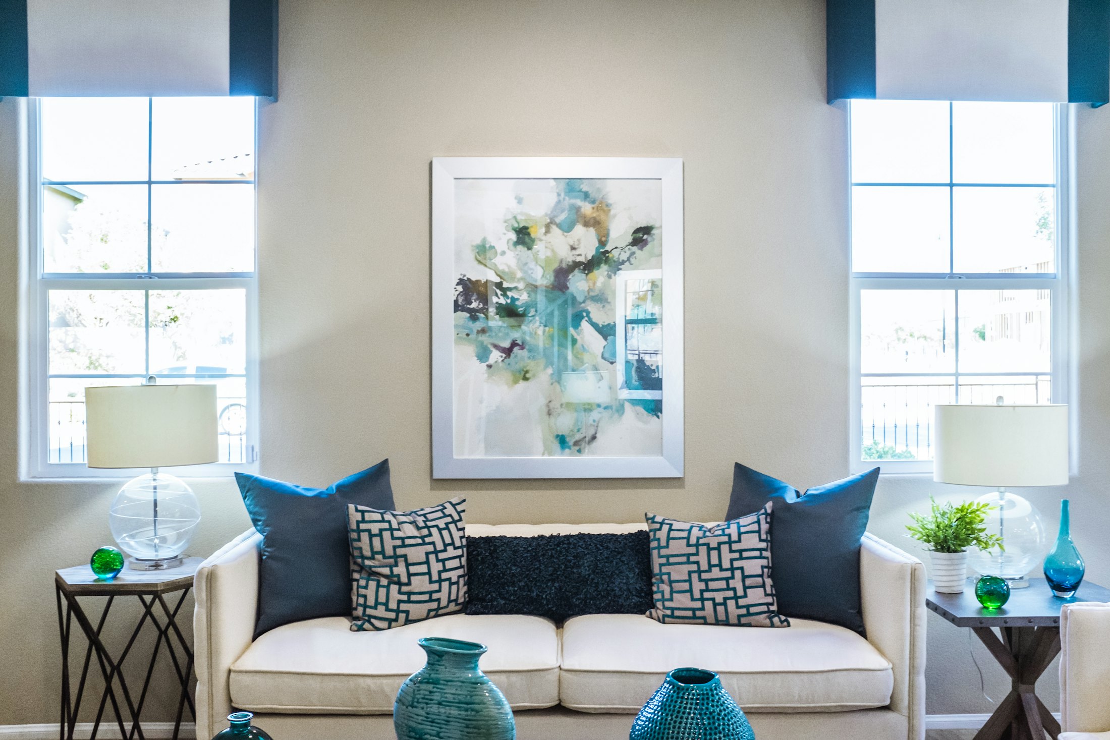 A styled living room with freshly painted neutral walls and white window frames