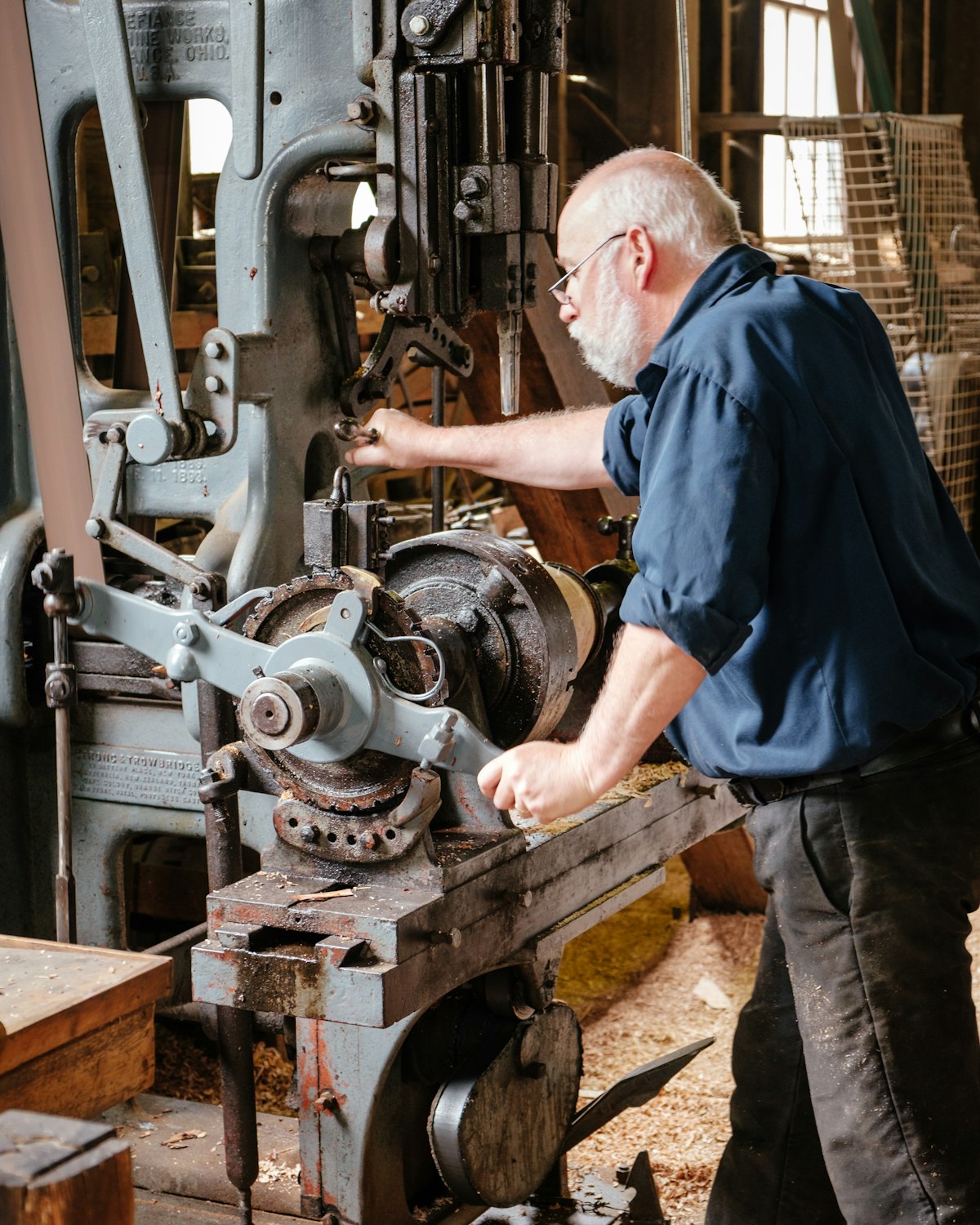 Uz, an experienced carpenter, working at a machine in his timber workshop