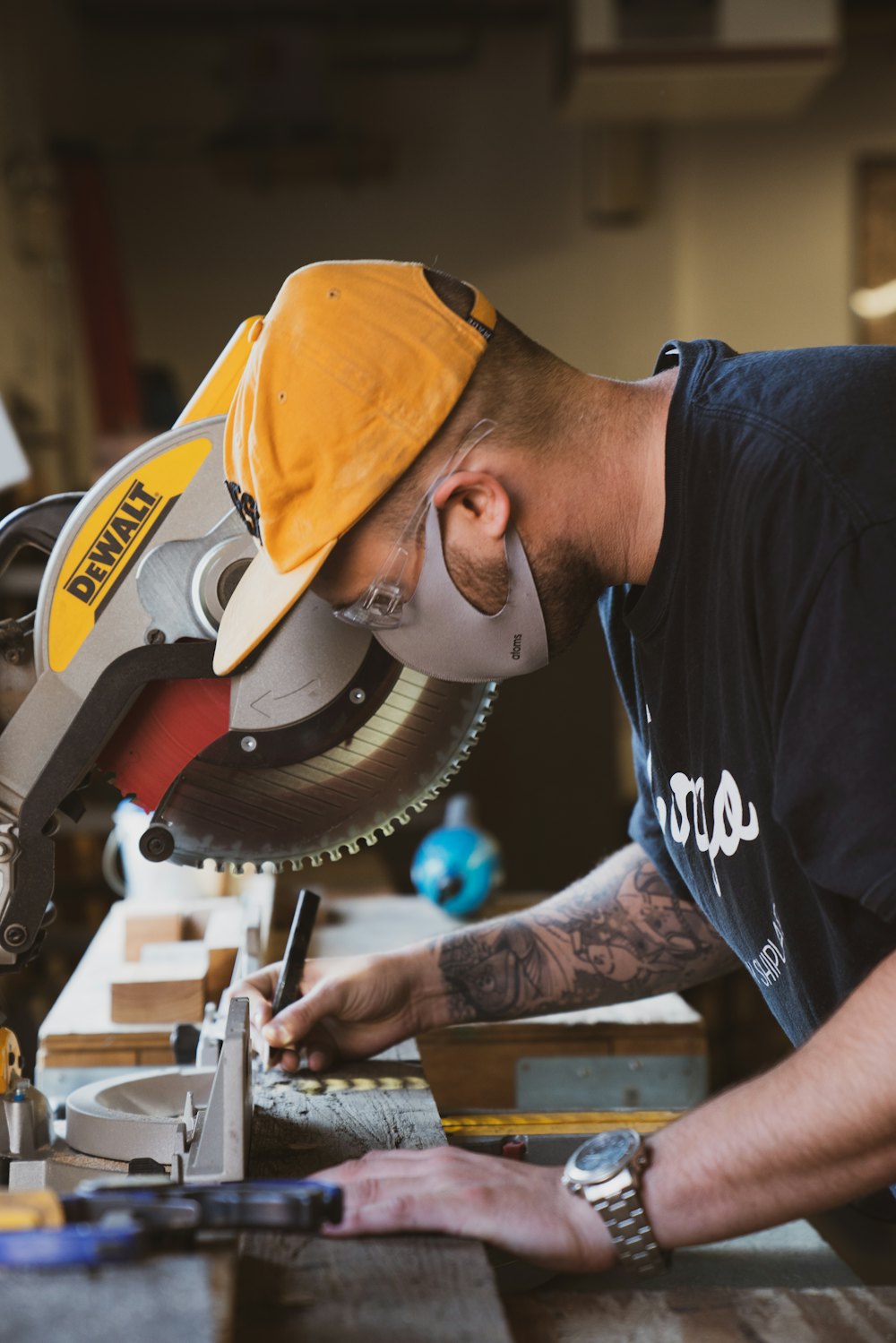 Carpenter making a precise cut on a mitre saw while building a frame