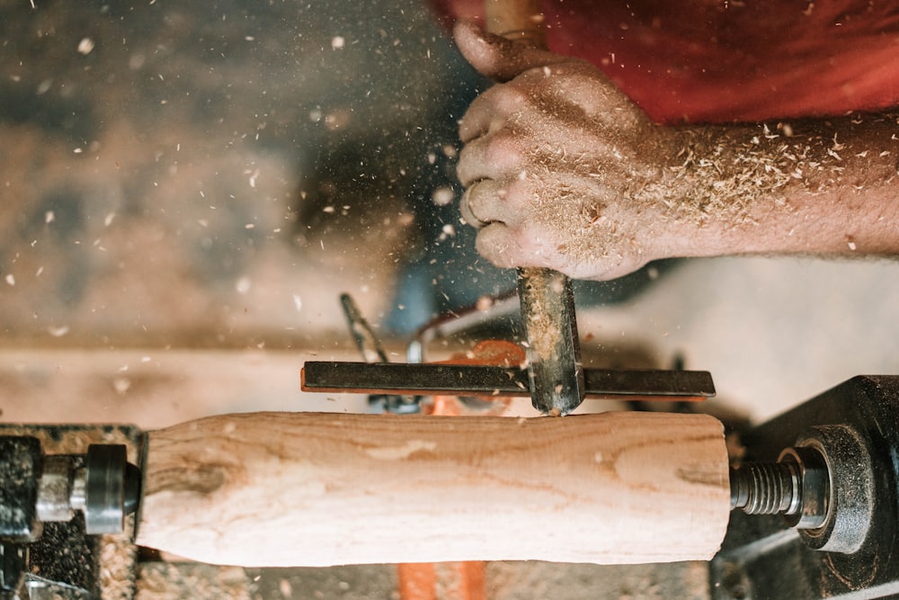 A timber baluster being shaped on a lathe with shavings flying